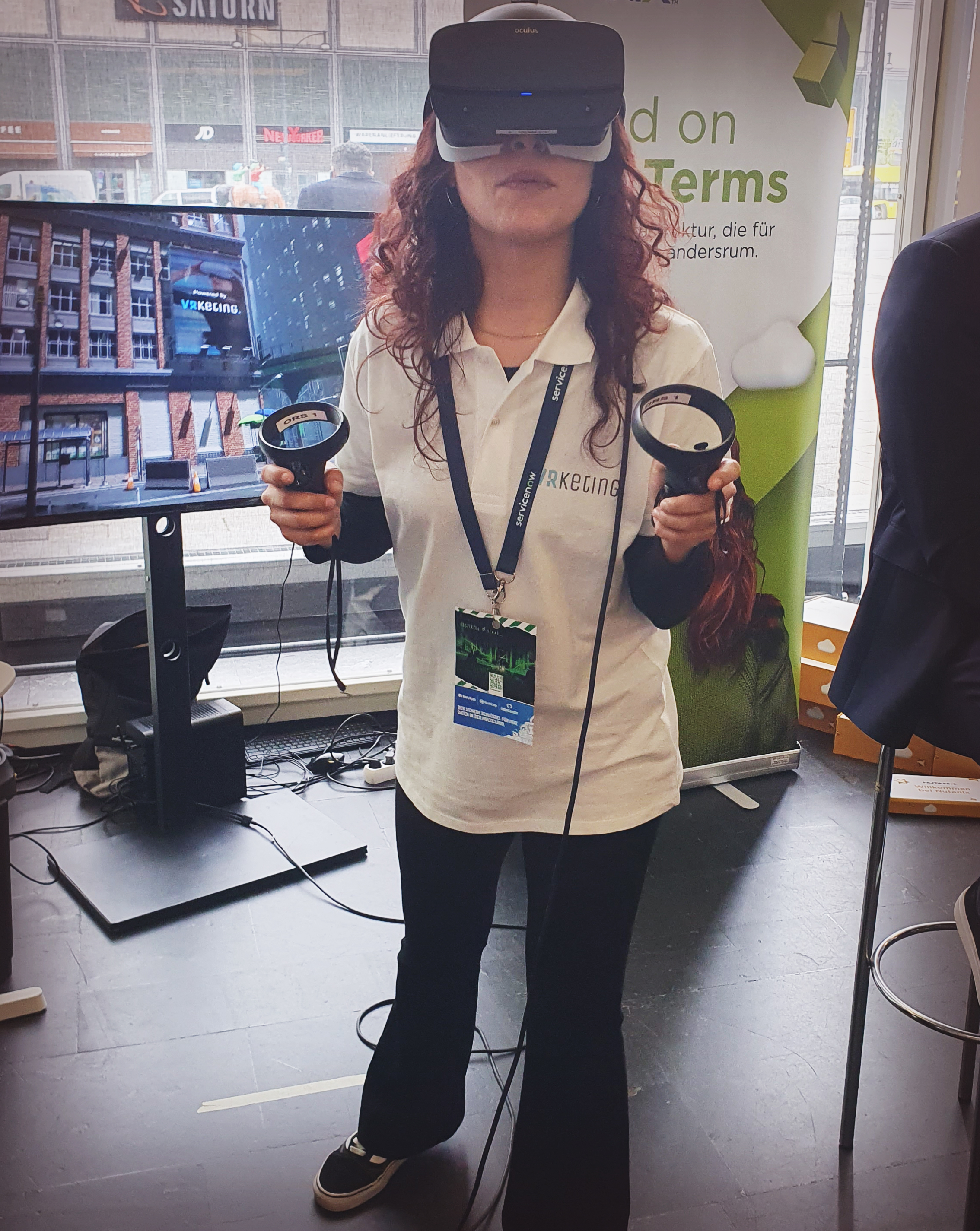 Several people operating a foosball table while wearing VR glasses